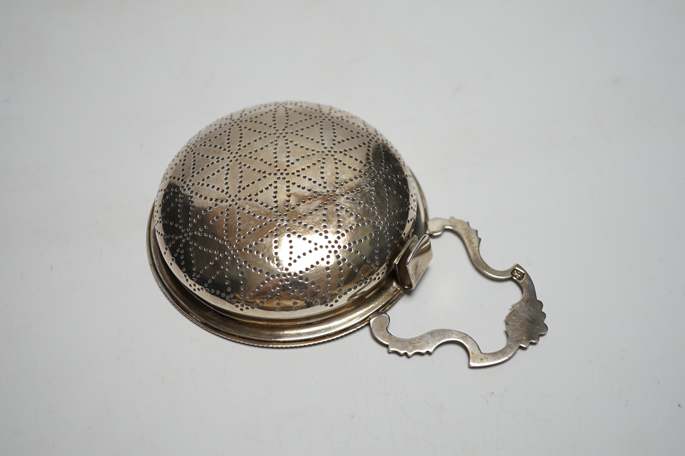 A late George II silver lemon strainer, maker WS?, London, 1759?, 14.7cm.